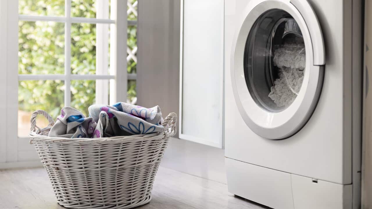 Laundry room with washing machine and laundry basket