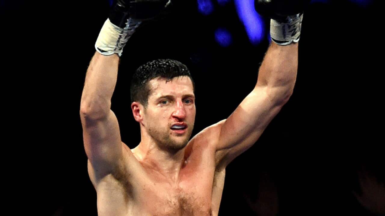 Carl Froch celebrates after knocks down George Groves