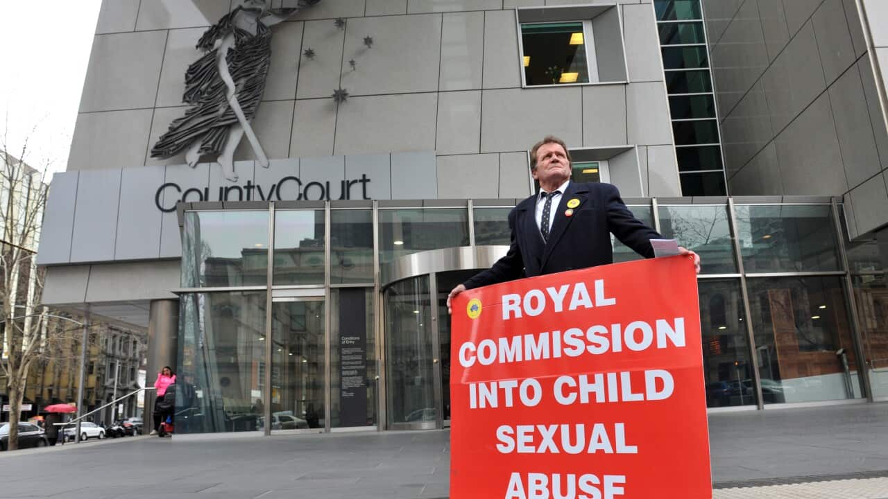 A man demonstrates outside The Commonwealth Royal Commission into Institutional Responses to Child Sexual Abuse at the County Court in Melbourne, Monday, Aug. 18, 2014.