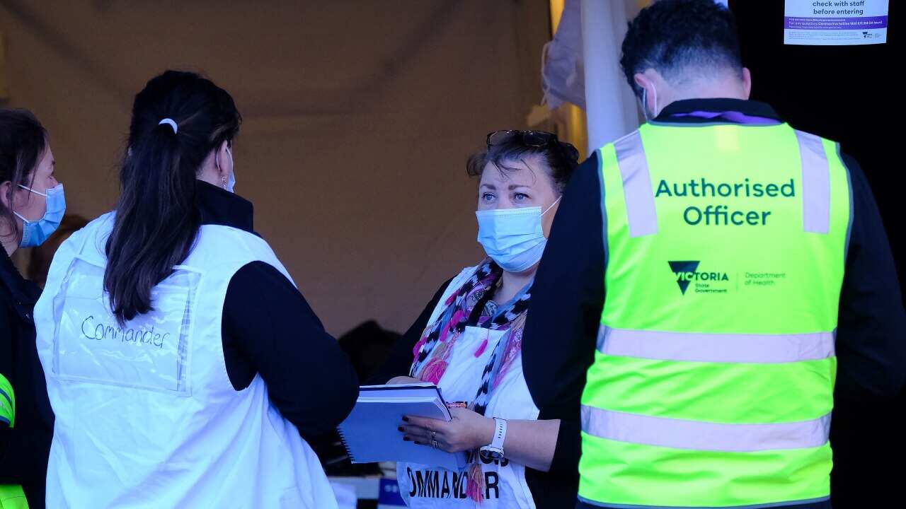 Health workers at Ariele Apartments in Maribyrnong, north-west of Melbourne, on Thursday, July 15, 2021.(AAP Image/Luis Ascui) NO ARCHIVING