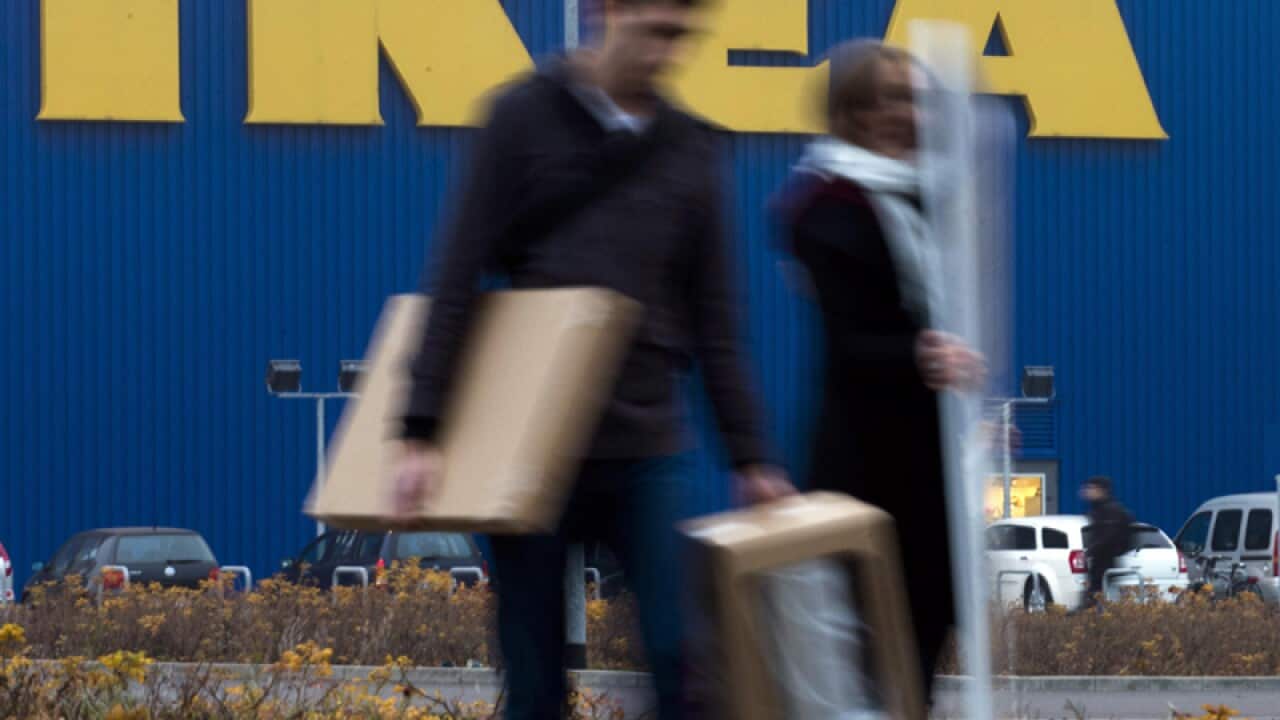 People walk in front of an IKEA shop