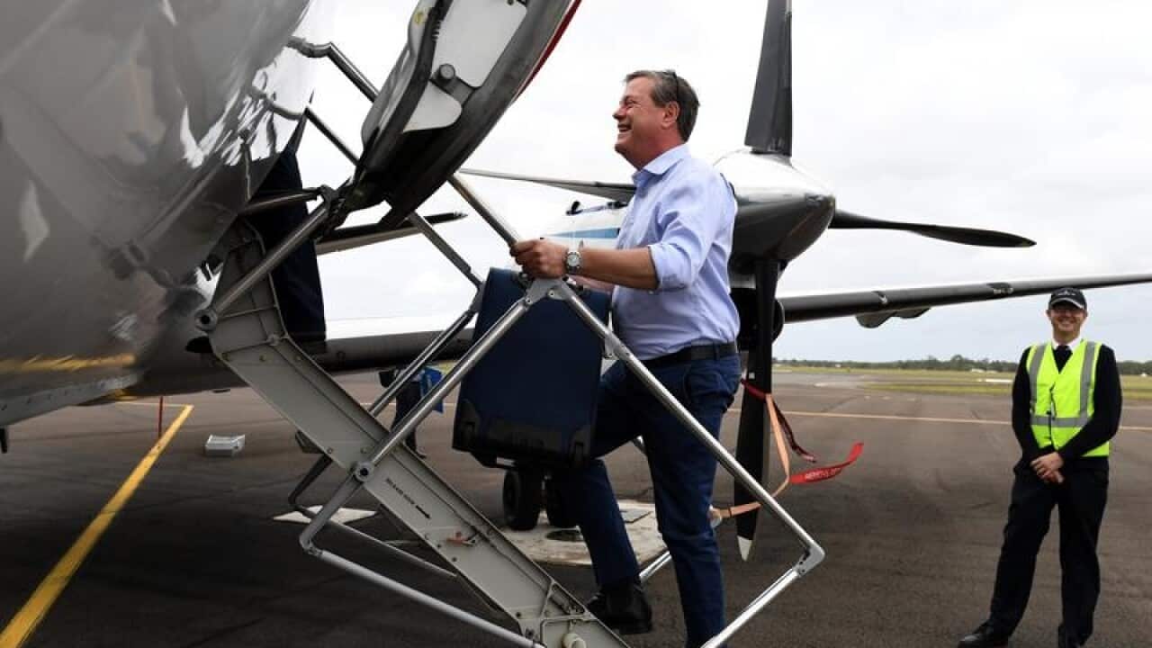 LNP leader Tim Nicholls boards a plane.