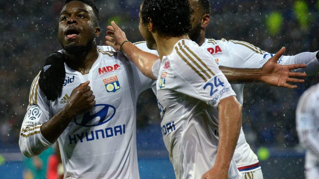 Lyon's French forward Maxwel Cornet (L) celebrates