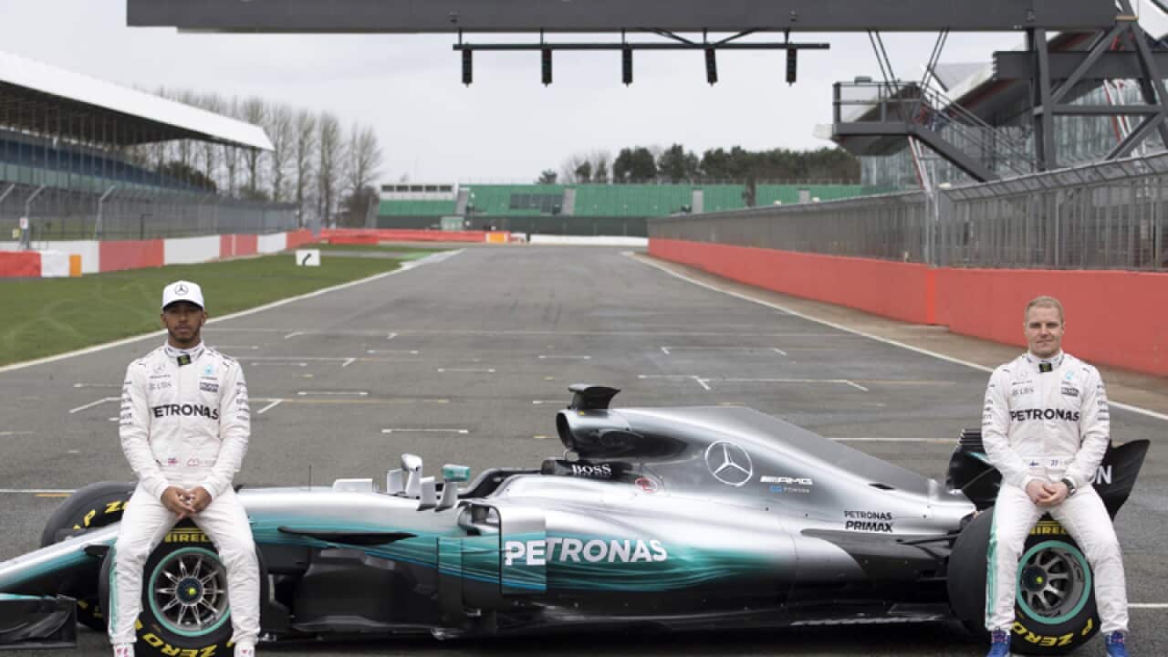 Mercedes F1 drivers Lewis Hamilton (L) and Valtteri Bottas