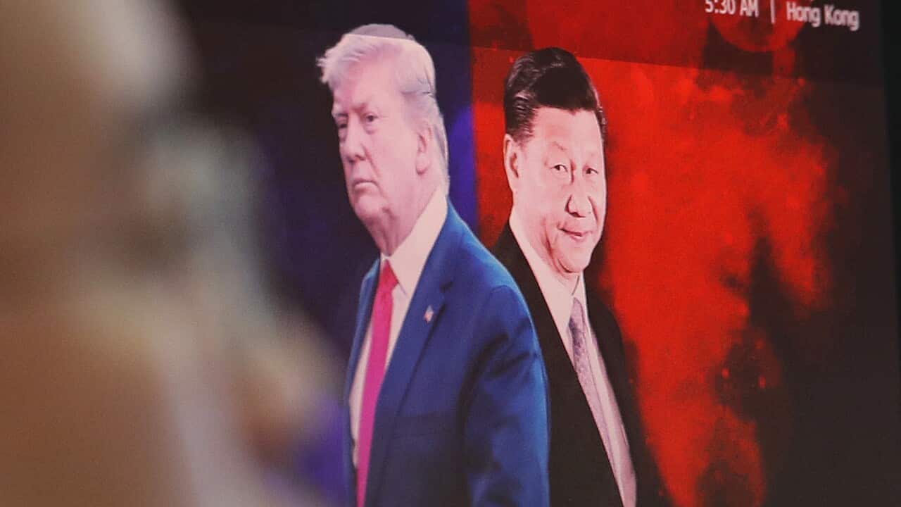 A computer screen shows images of Chinese President Xi Jinping, right, and U.S. President Donald Trump.