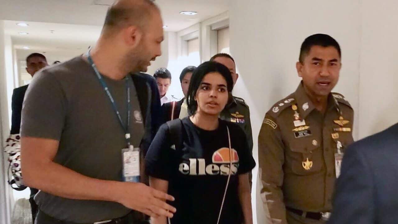 Rahaf Mohammed al-Qunun chats with Thai Immigration Police Chief Surachet Hakparn and an unidentified UNHCR officer at the Suvarnabhumi international airport.