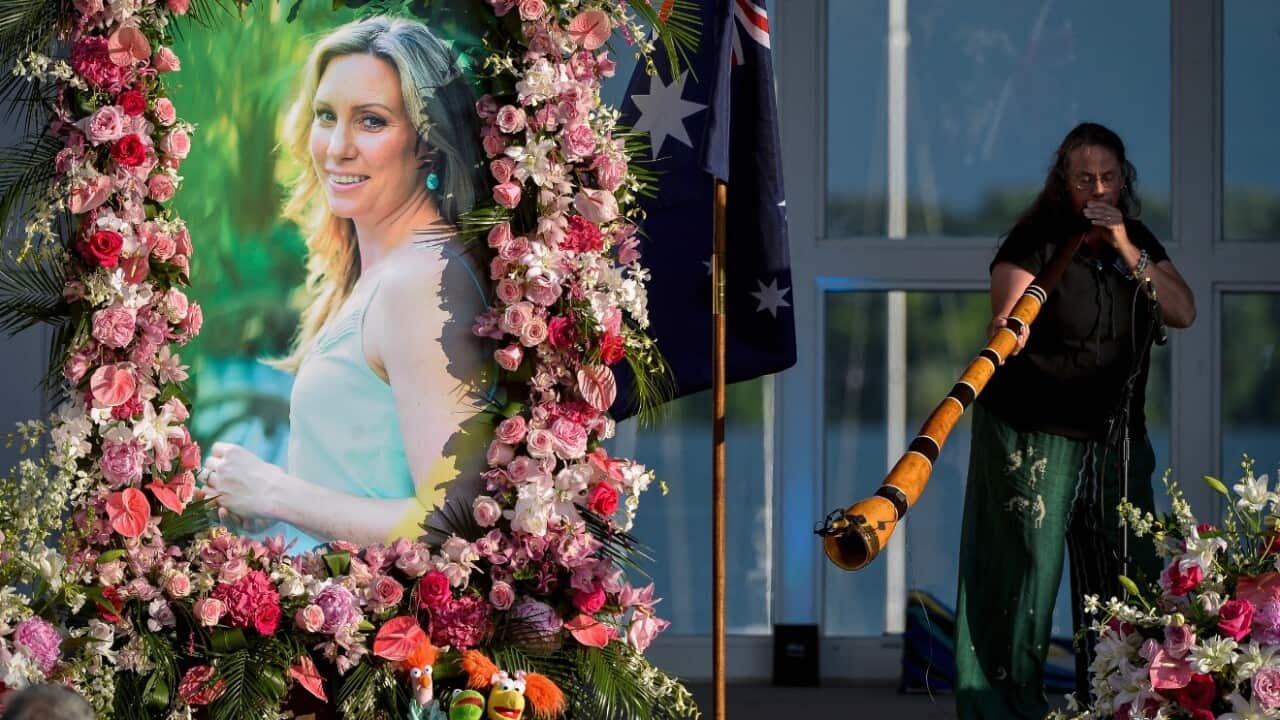 In this Aug. 11, 2017, file photo, Johanna Morrow plays the didgeridoo during a memorial service for Justine Damond in Minneapolis