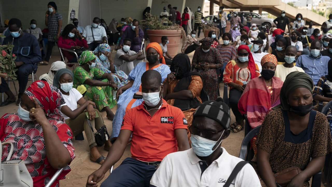 People wait to be vaccinated at Leopold Sedar Senghor stadium in Dakar, Senegal
