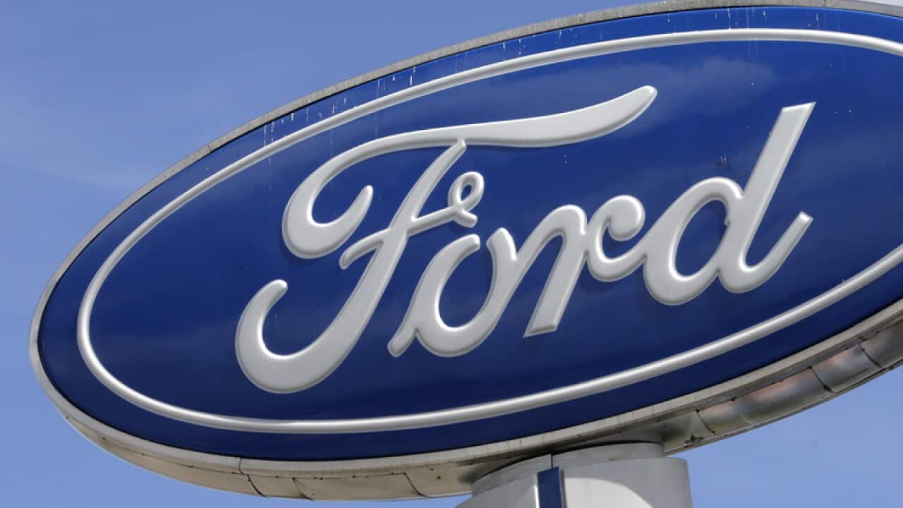 A Ford sign at an auto dealership