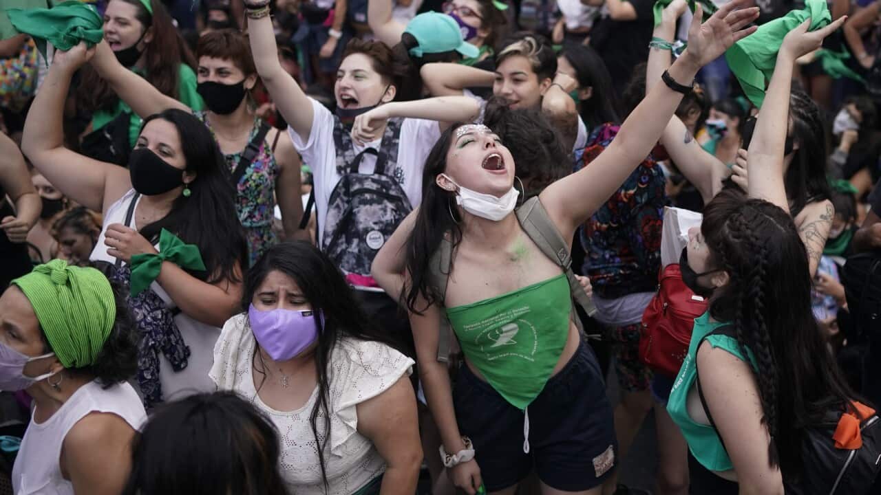 Abortion-rights activists shout slogans outside Congress in Buenos Aires, Argentina, Friday, Dec. 11, 2020. The Argentine lower house has approved a bill that would legalize abortion. The bill now moves to the Senate.