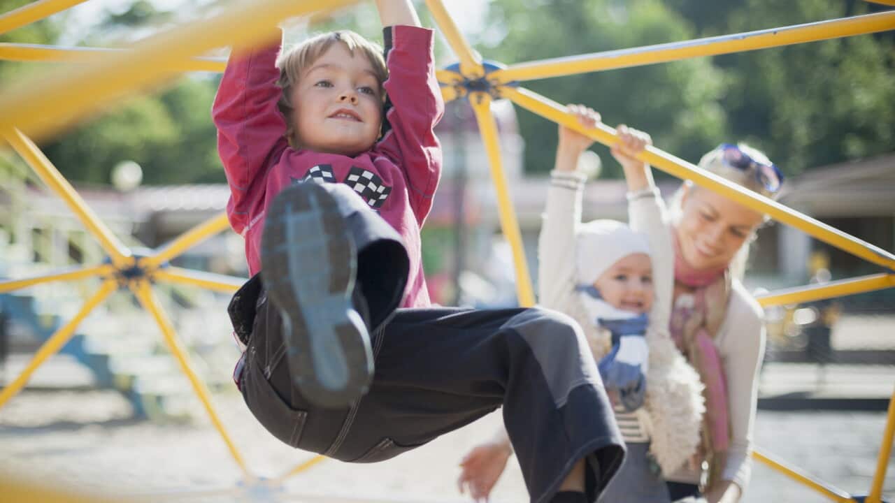 mother with 2 children on playground
