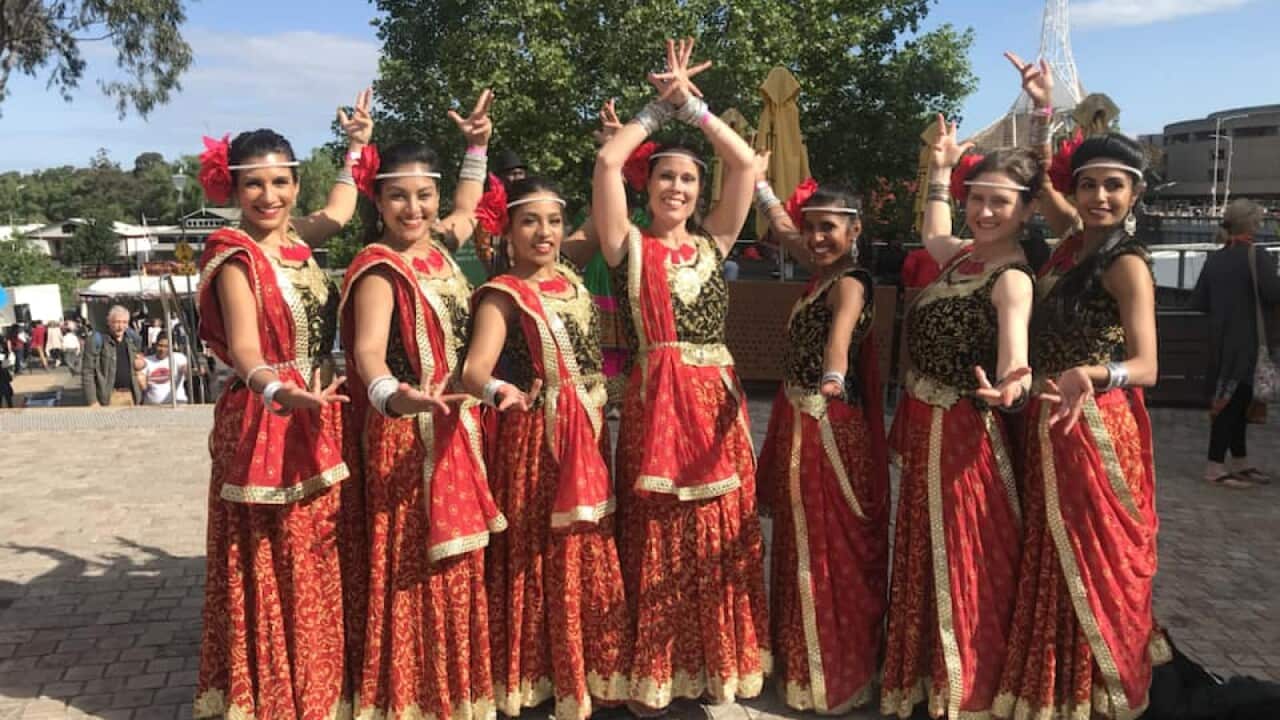 Indian people dressed in traditional attire to perform the traditional dance during a Diwali celebration at Federation Square in Melbourne.