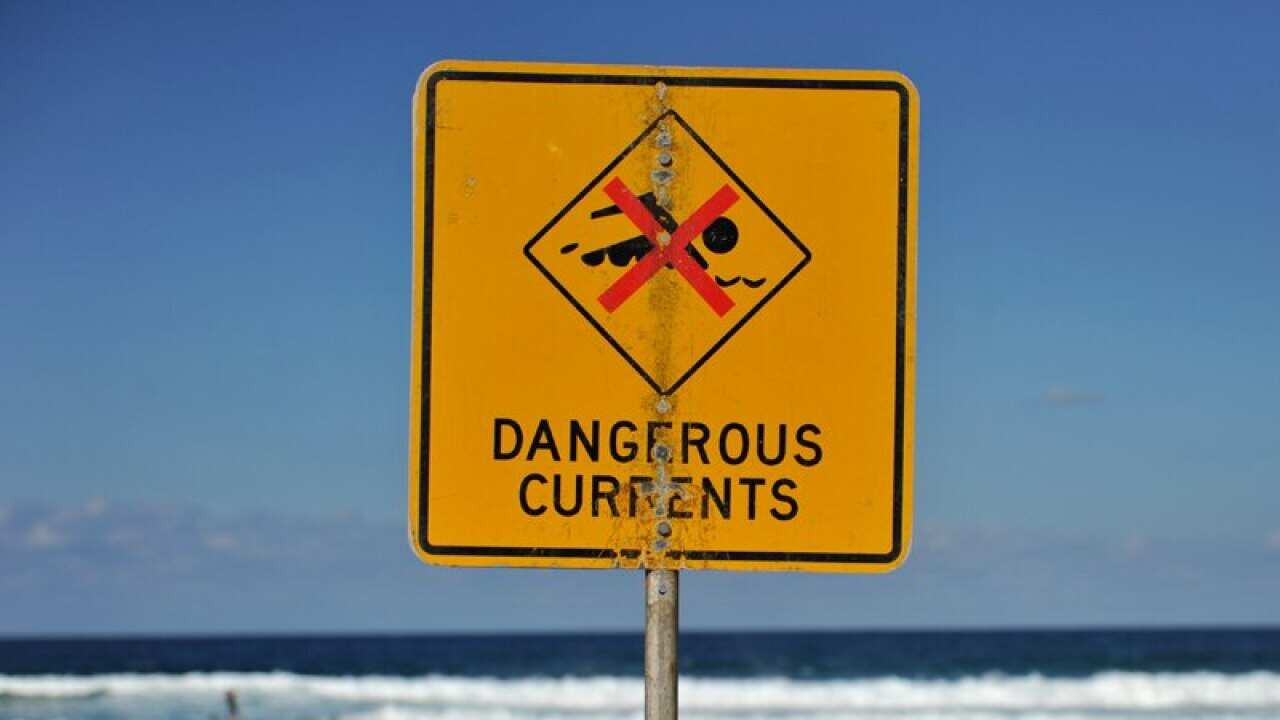 A sign warning of dangerous currents alerts