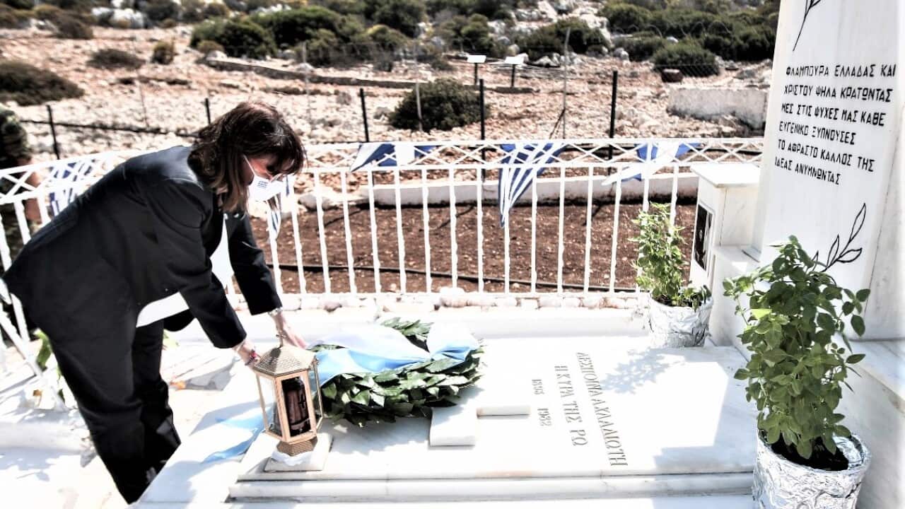 Greek President Katerina Sakellaropoulou laying a wreath on a local monument on the island of Ros.