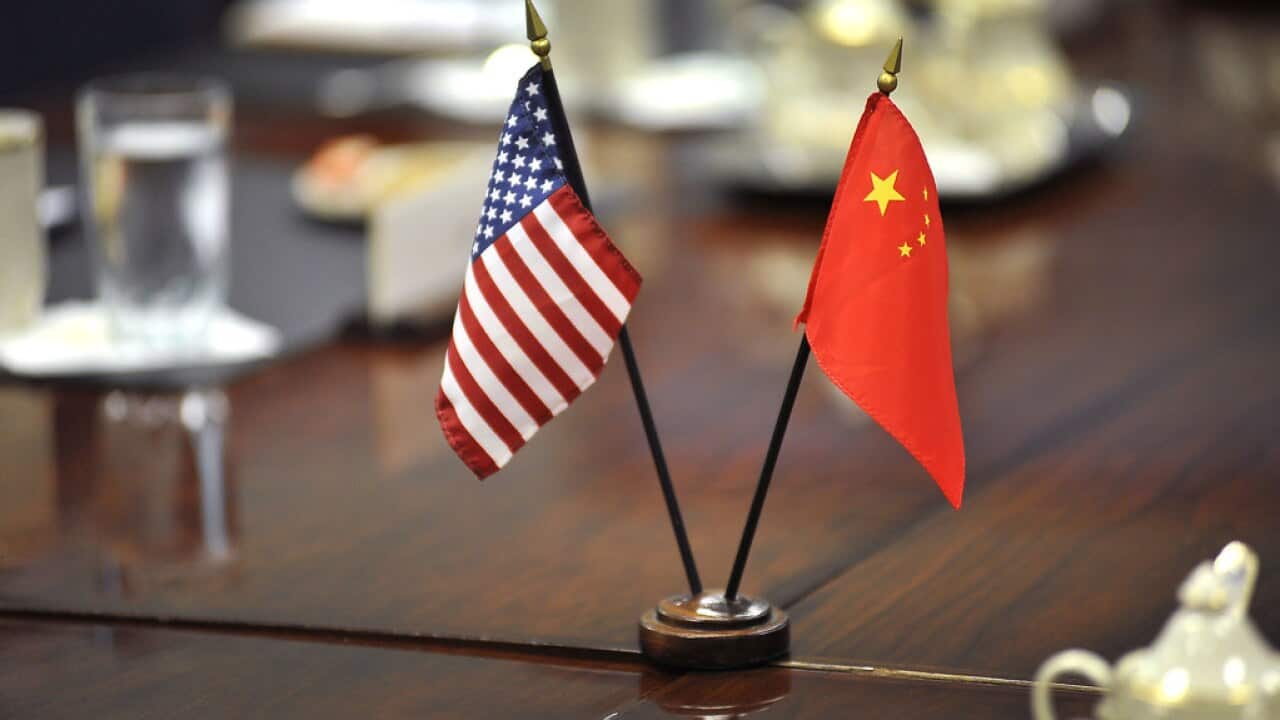 US & China flags on the negotiation table