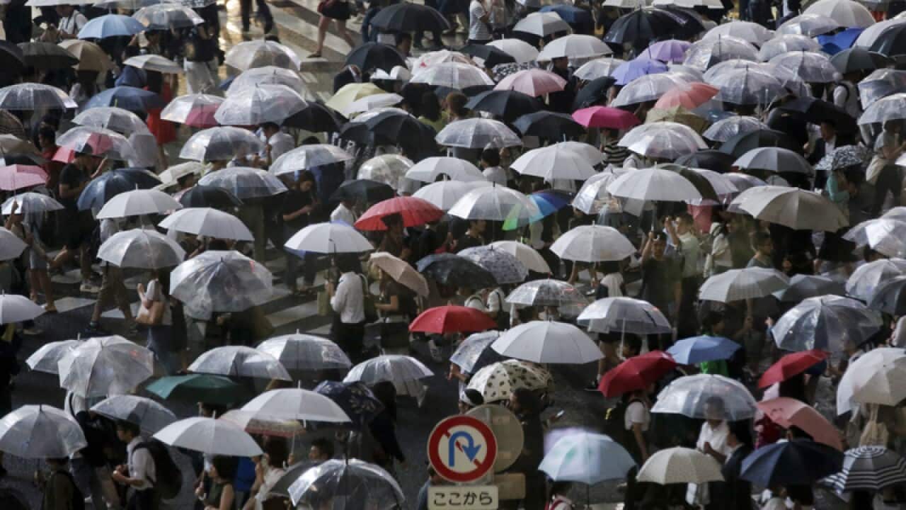 Pedestrians crowd a street in Tokyo