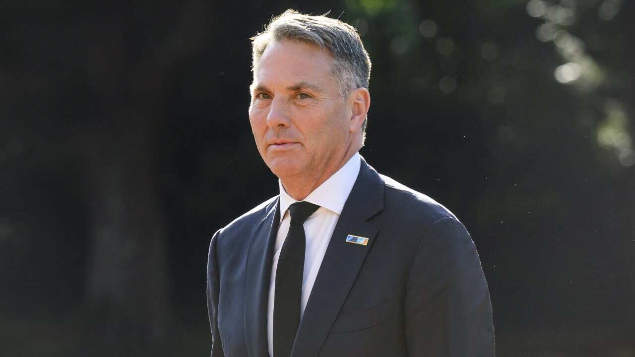 Richard Marles wearing a black suit and white shirt