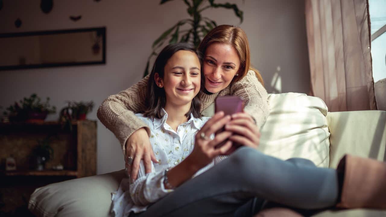 Mother and daughter using a smartphone