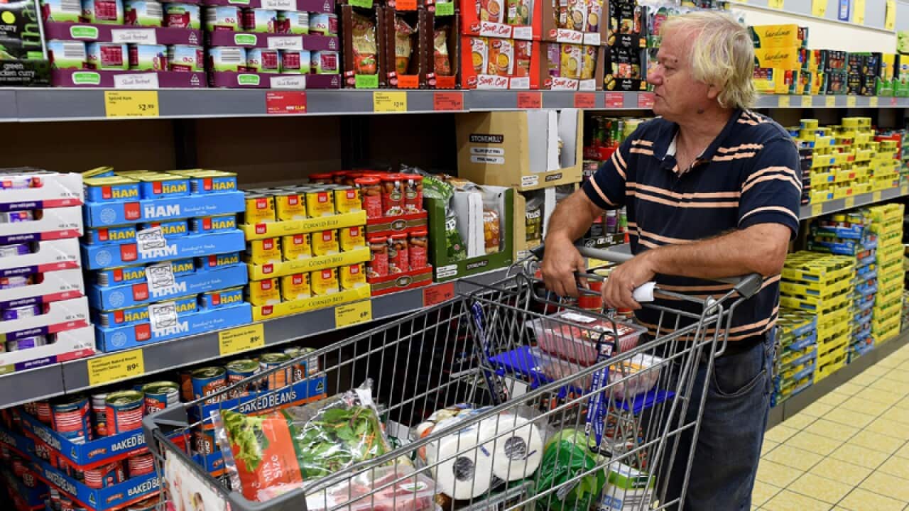 A pensioner shops in a grocery store