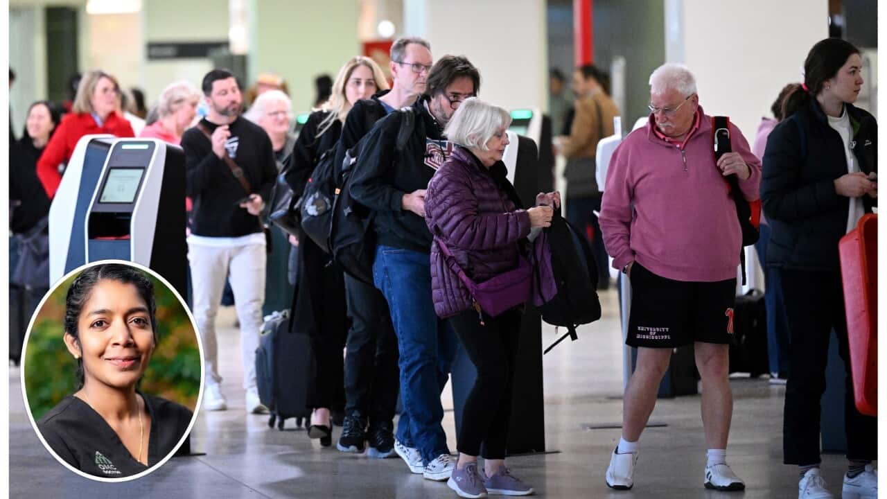 People are seen in line at the Qantas domestic arrivals terminal at Melbourne International Airport in Melbourne