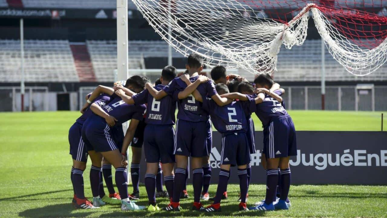 Members of the Thai football team, the Wild Boars, embrace each other before a friendly soccer match in Buenos Aires, Argentina.