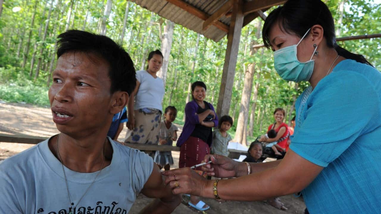 A Laotian villager receives a vaccination shot at a village in Luang (ROSLAN RAHMAN - AFP - Getty Images)