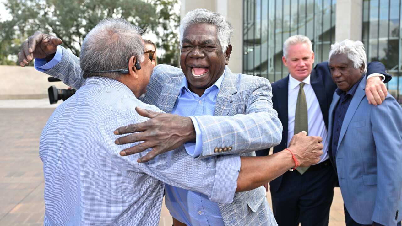 Gumatj leaders Djawa Yunupingu and Balupalu Yunupingu celebrate outside the High Court of Australia in Canberra, Wednesday, March 12, 2025.