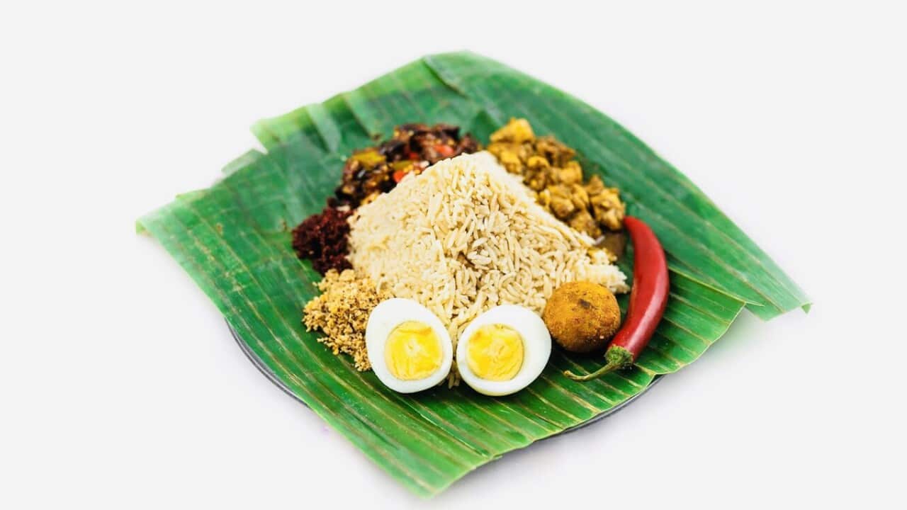 Lamprais is served on a banana leaf and contains a bed of rice cooked in stock, mixed meats, eggplant pickle, chilli paste and other condiments.