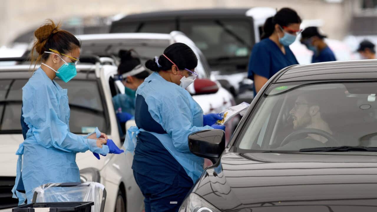 Healthcare workers collect patient details at the St Vincent’s Hospital drive-through testing clinic at Bondi Beach in Sydney, Friday, 17 December, 2021.