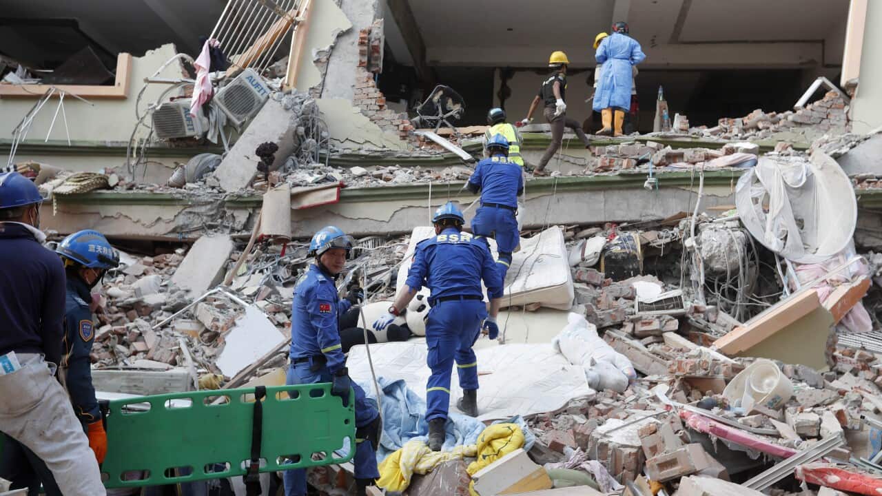 Rescuers searching through rubble.
