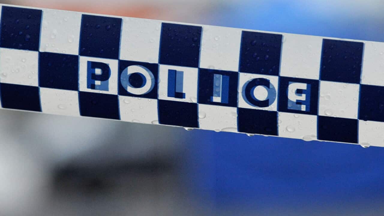 Police tape restricts access to a crime scene