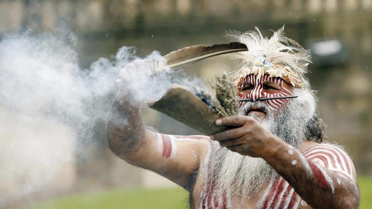An Aboriginal elder performs a ritual following the return of indigenous remains