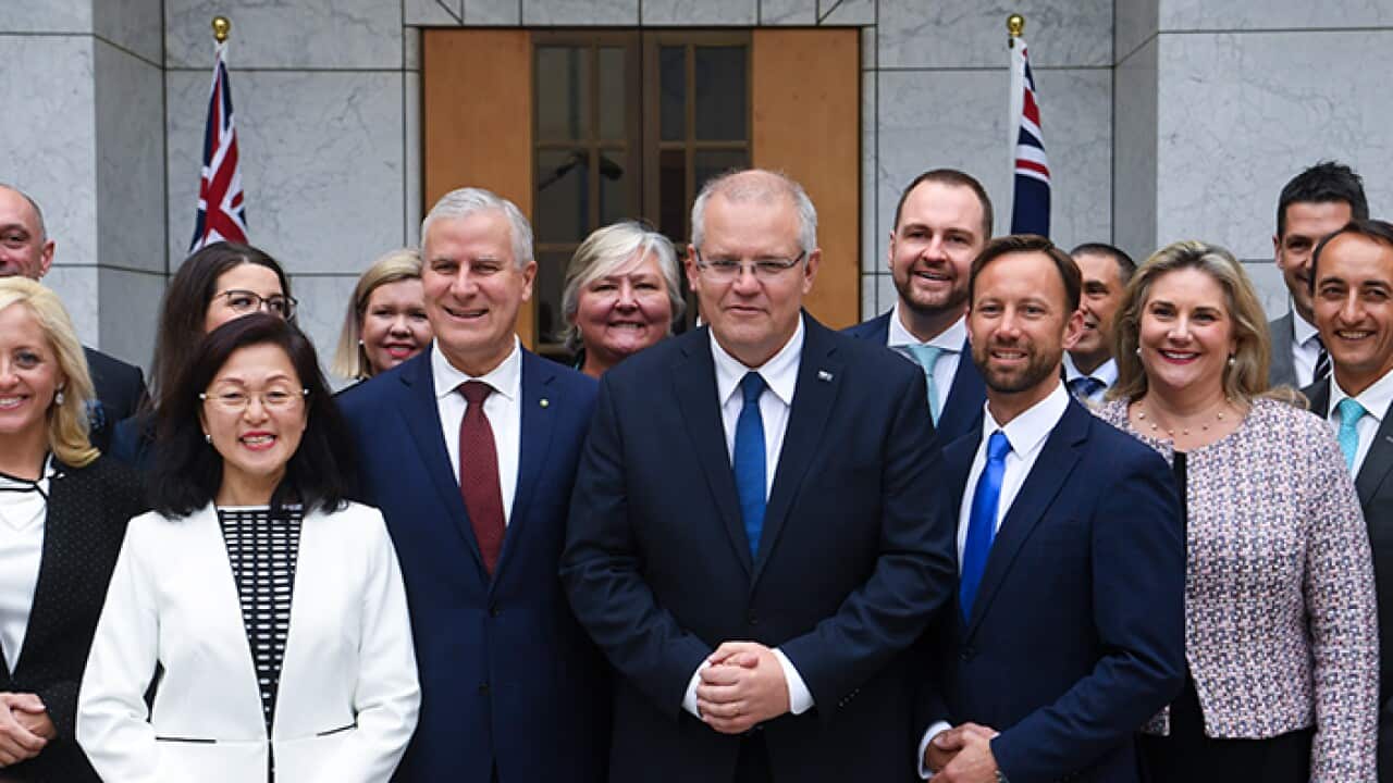 Australian Prime Minister Scott Morrison and Australian Deputy Prime Minister Michael McCormack pose for photographs with newly-elected Coalition MPs at Parliament House