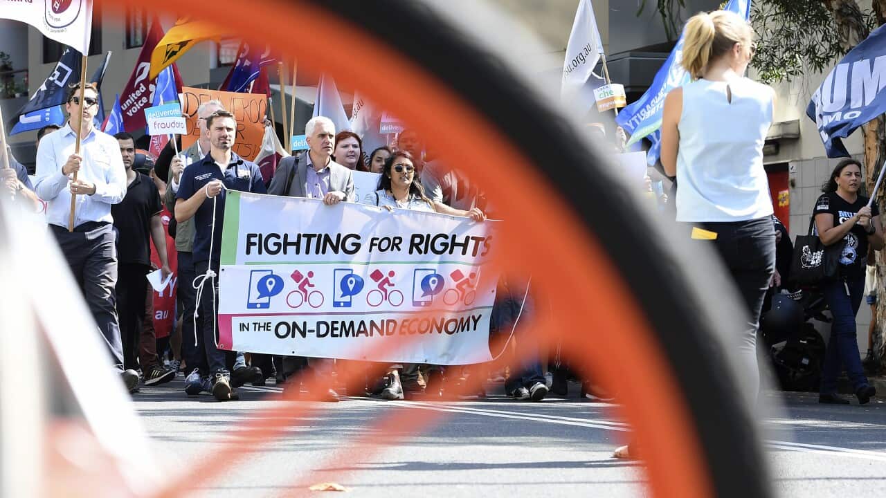 Protesters rally in support of food delivery riders in Sydney.