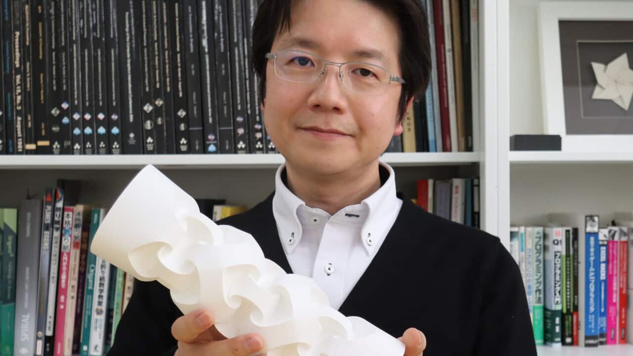 Professor Jun Mitani with his Origami work