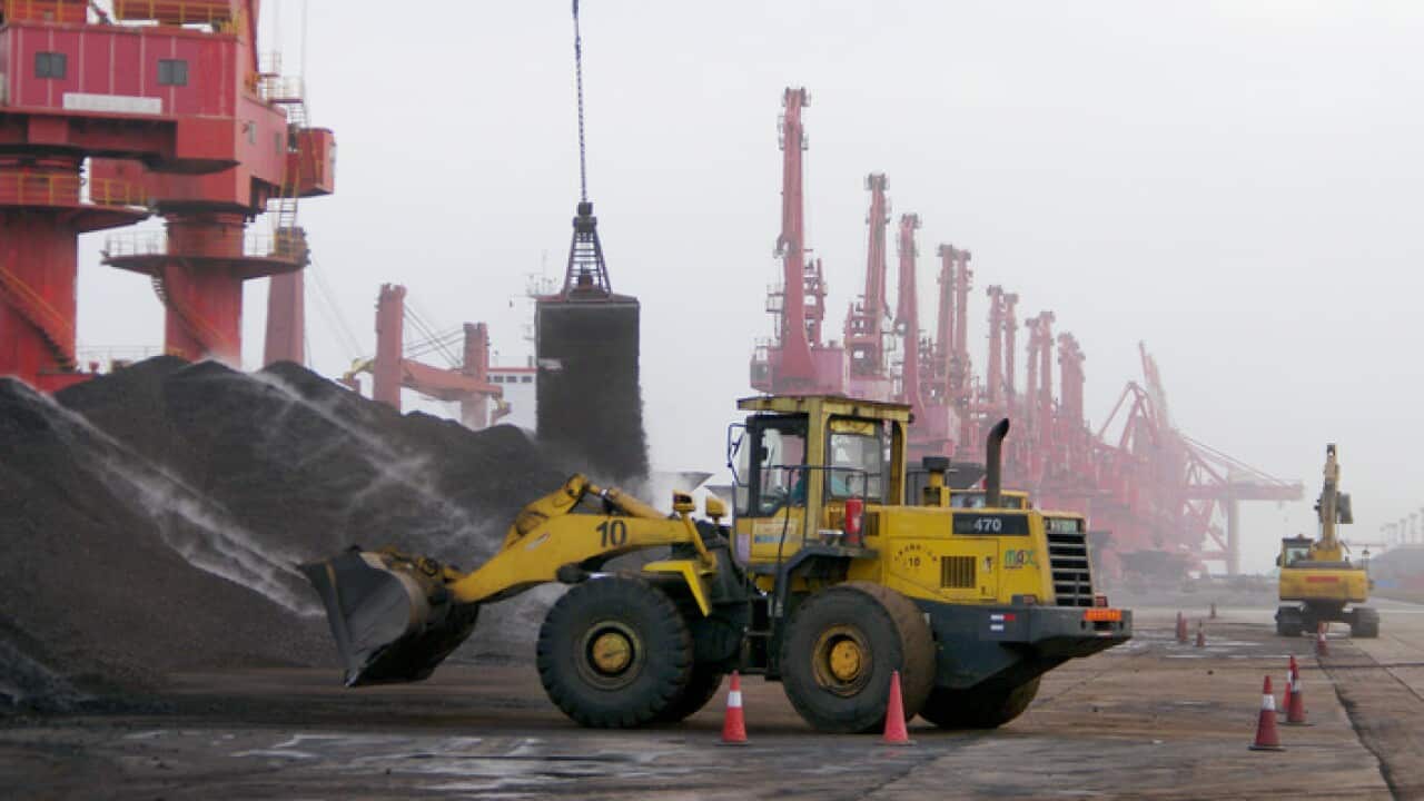A bucket grab unloads coal at Port of Rizhao east of China