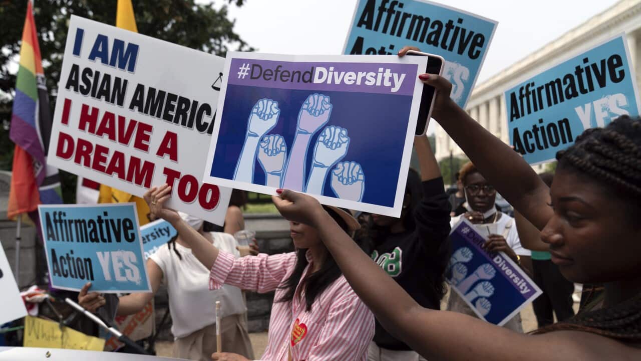 Protesters in support of affirmative action holding placards.