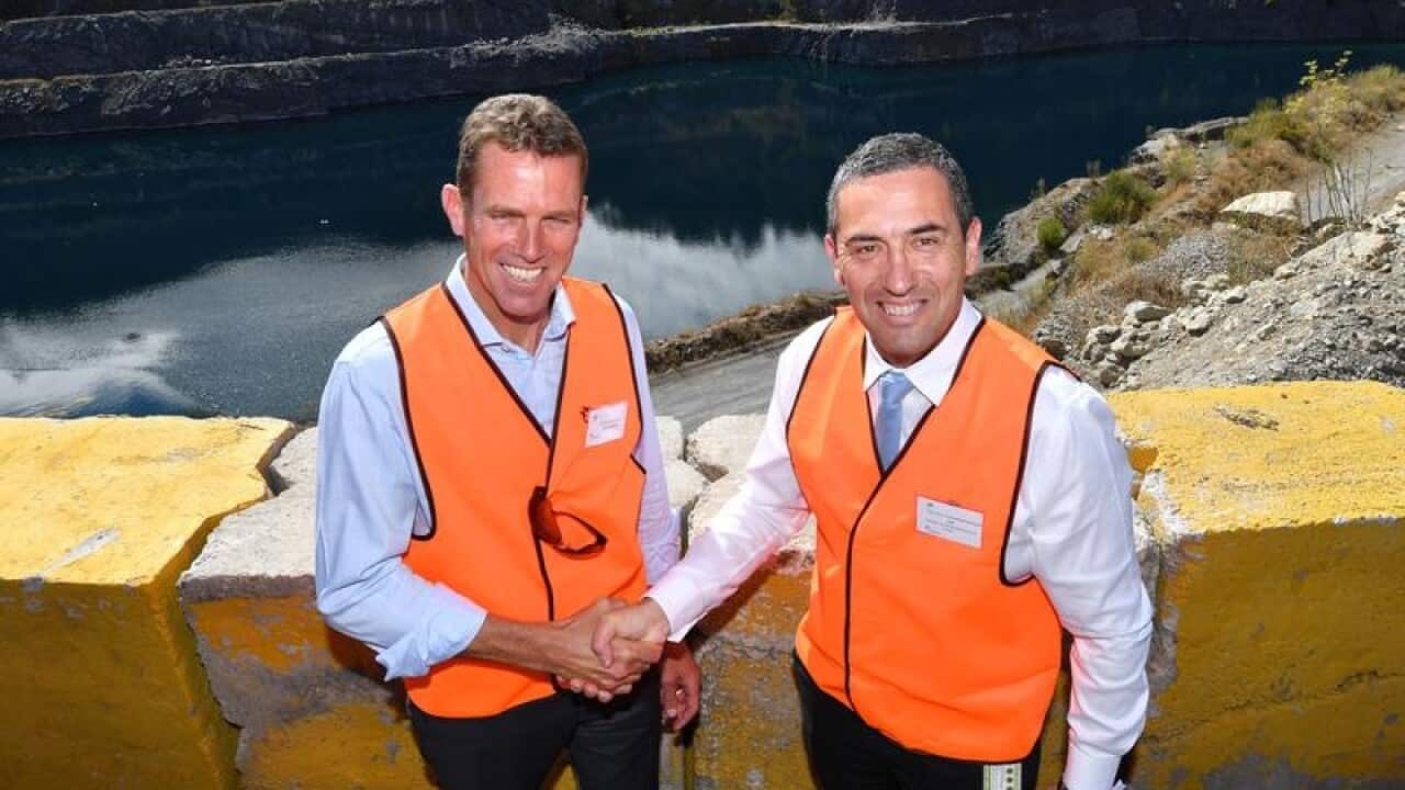 MP Tom Koutsantonis and Deion Campbell shake hands at a quarry.