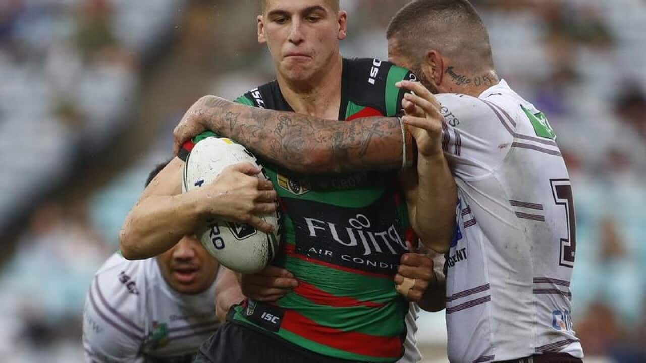 Adam Doueihi of the Rabbitohs is tackled.