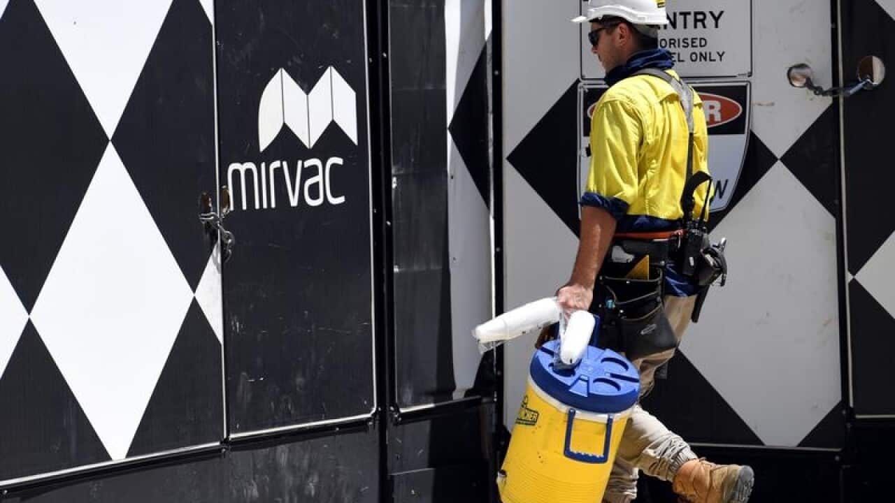 A worker enters a Mirvac construction site in Sydney