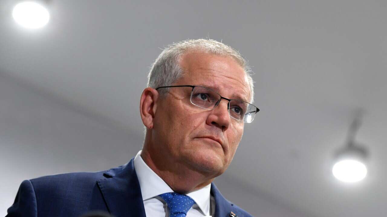 A man listening at a press conference.