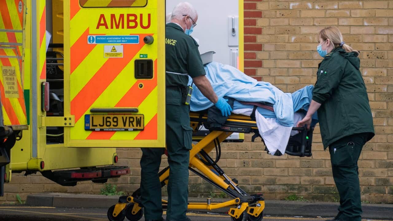 Paramedics transfer a patient from an ambulance into Southend University hospital in Essex