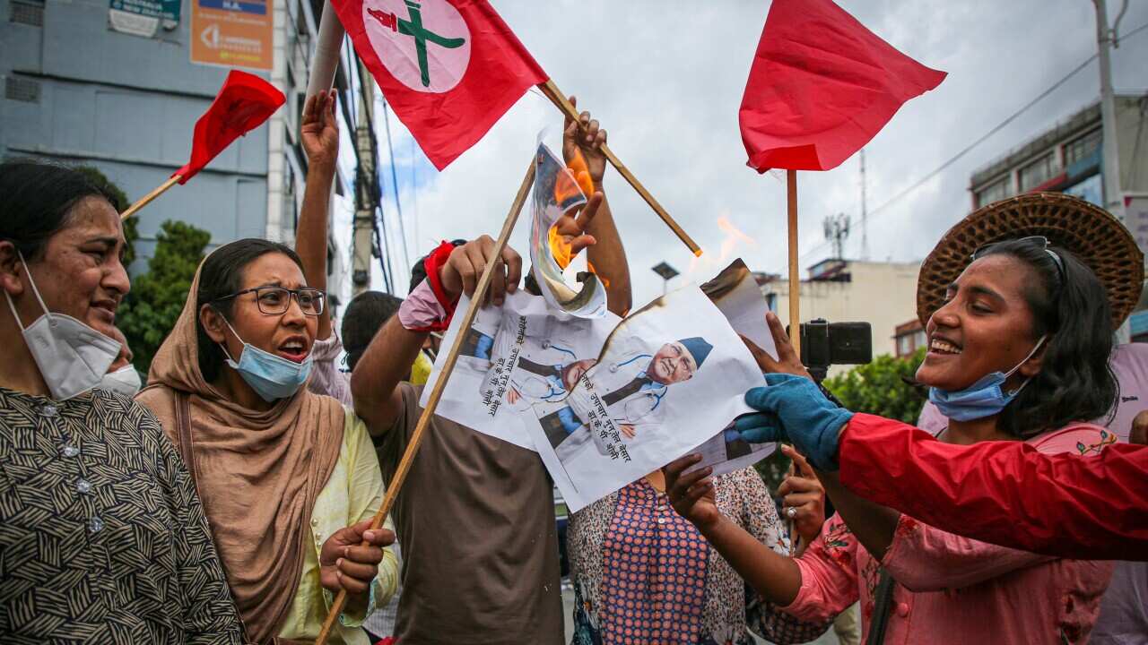 Protesters in Nepal burn placards with a photo of the prime minister KP Oli during the demonstration.Protest against government? poor handling of the COVID-19 crisis by lack of transparency and corruption. (Photo by Sujan Shrestha / SOPA Images/Sipa USA)