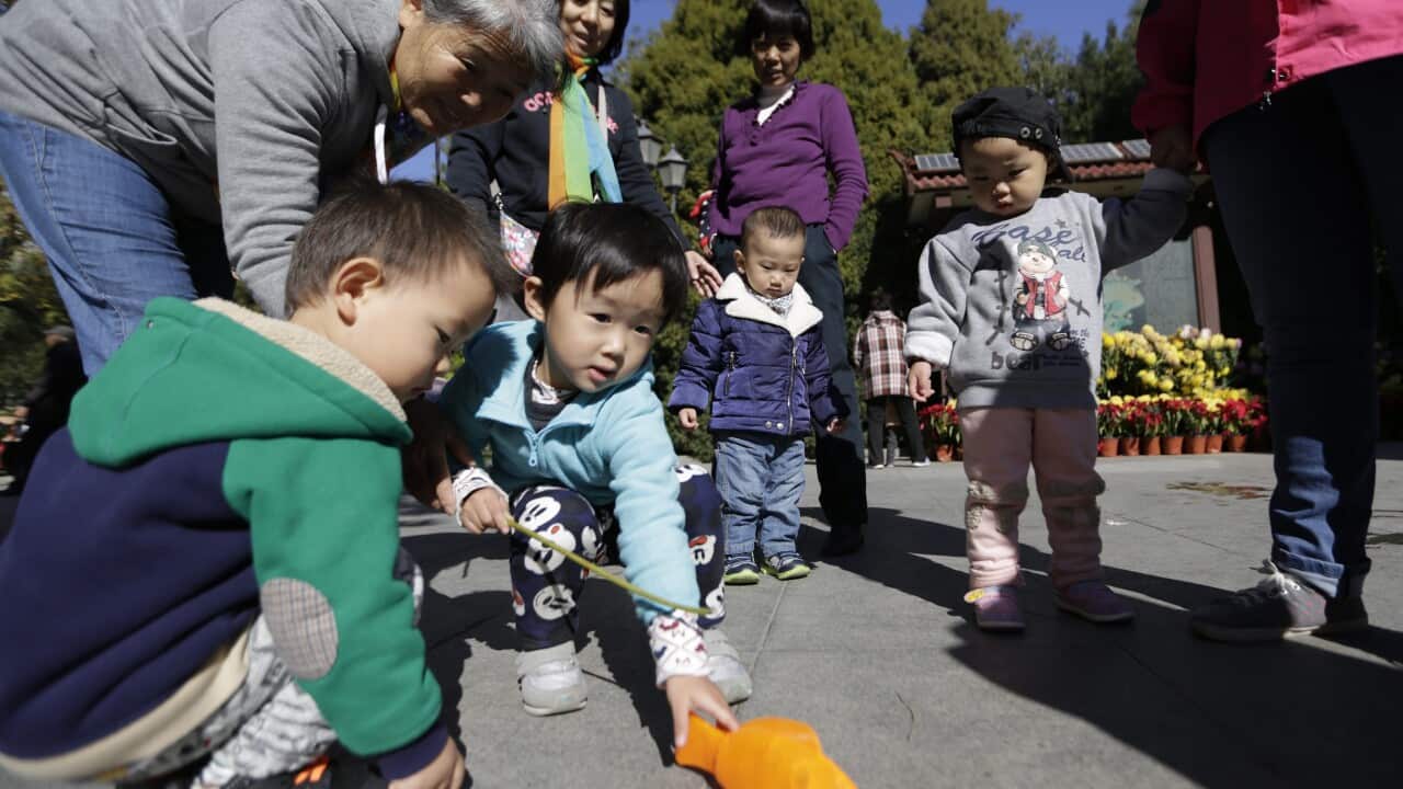 Chinese children and their family play in a park in Beijing, China, 30 October 2015.