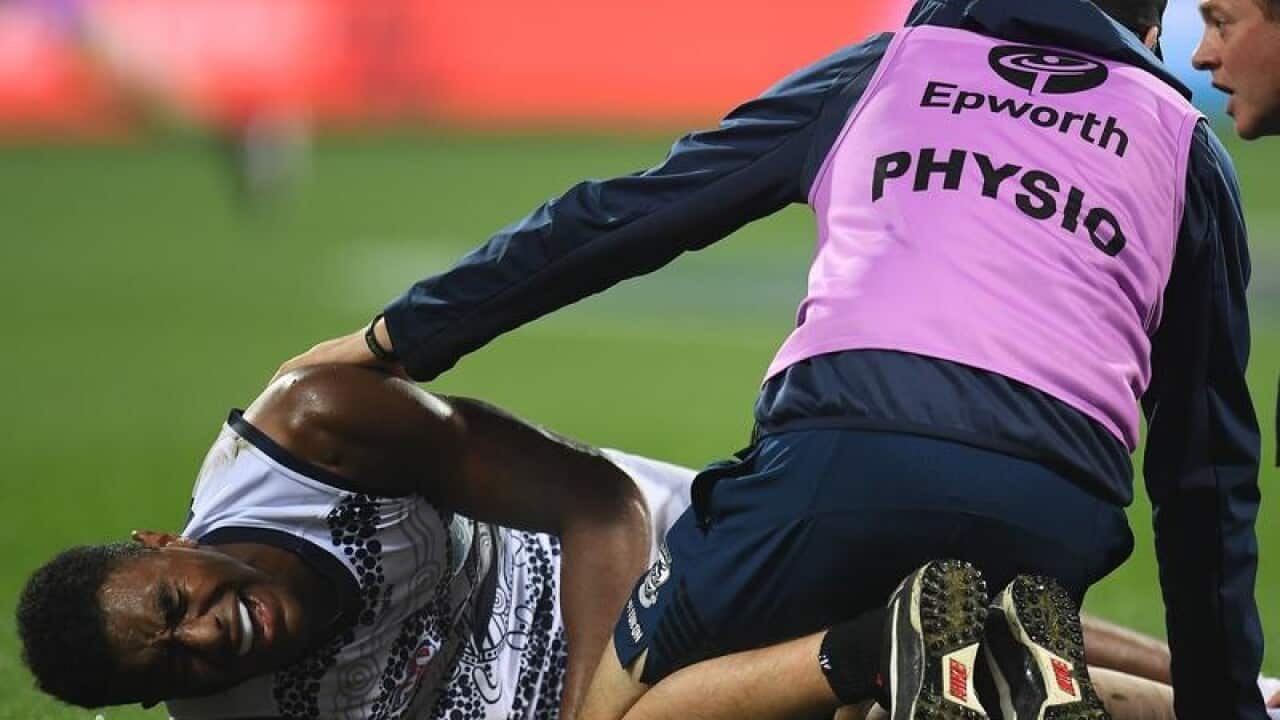 Geelong Cats player Esava Ratugolea is seen after sustaining an injury