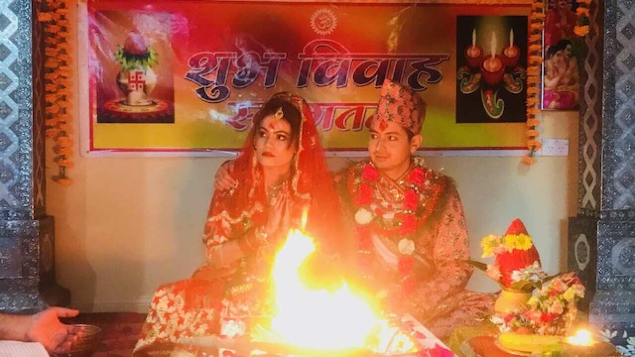 A young Hindu Nepalese Australian couple wed at small backyard service. 