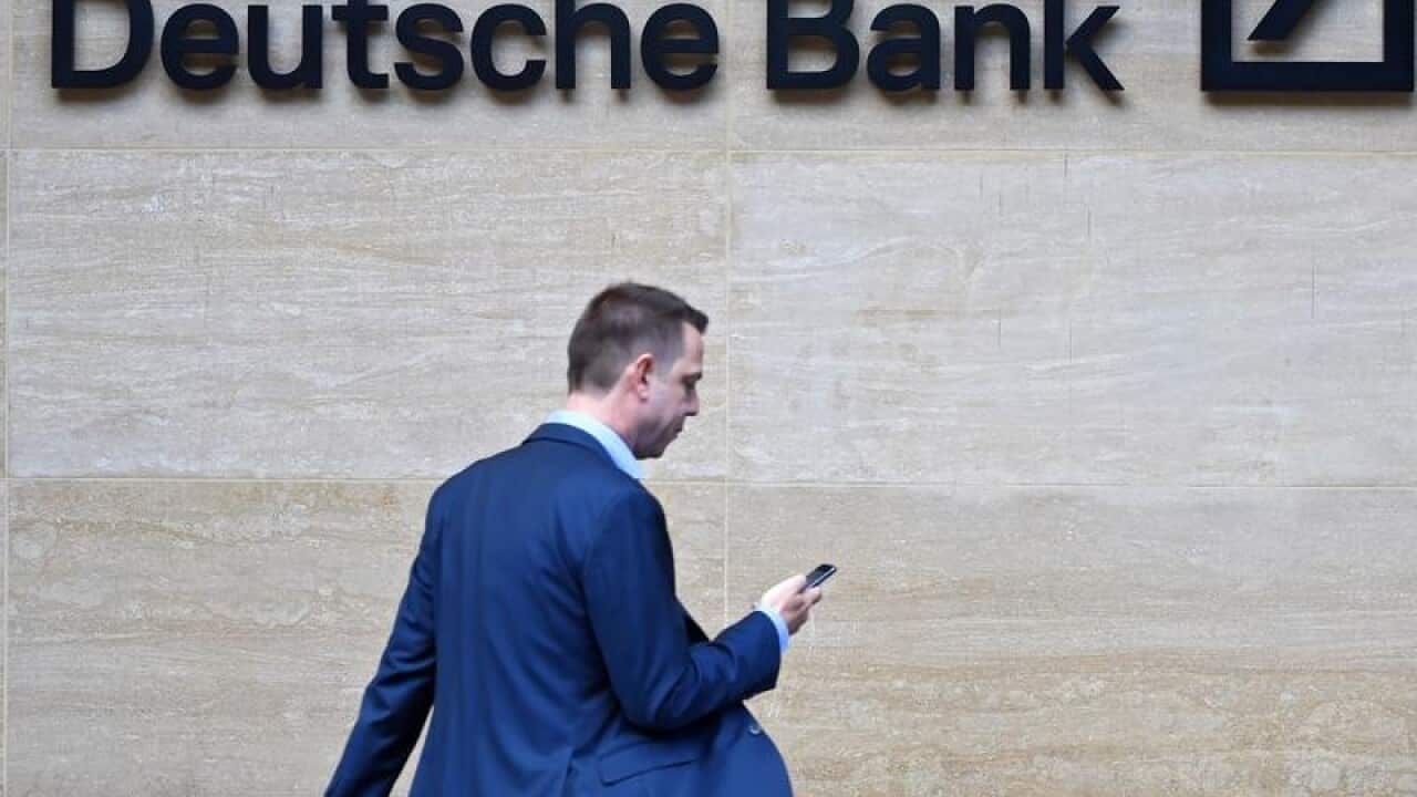 Man walks past by the British headquarters of the German Deutsche Bank