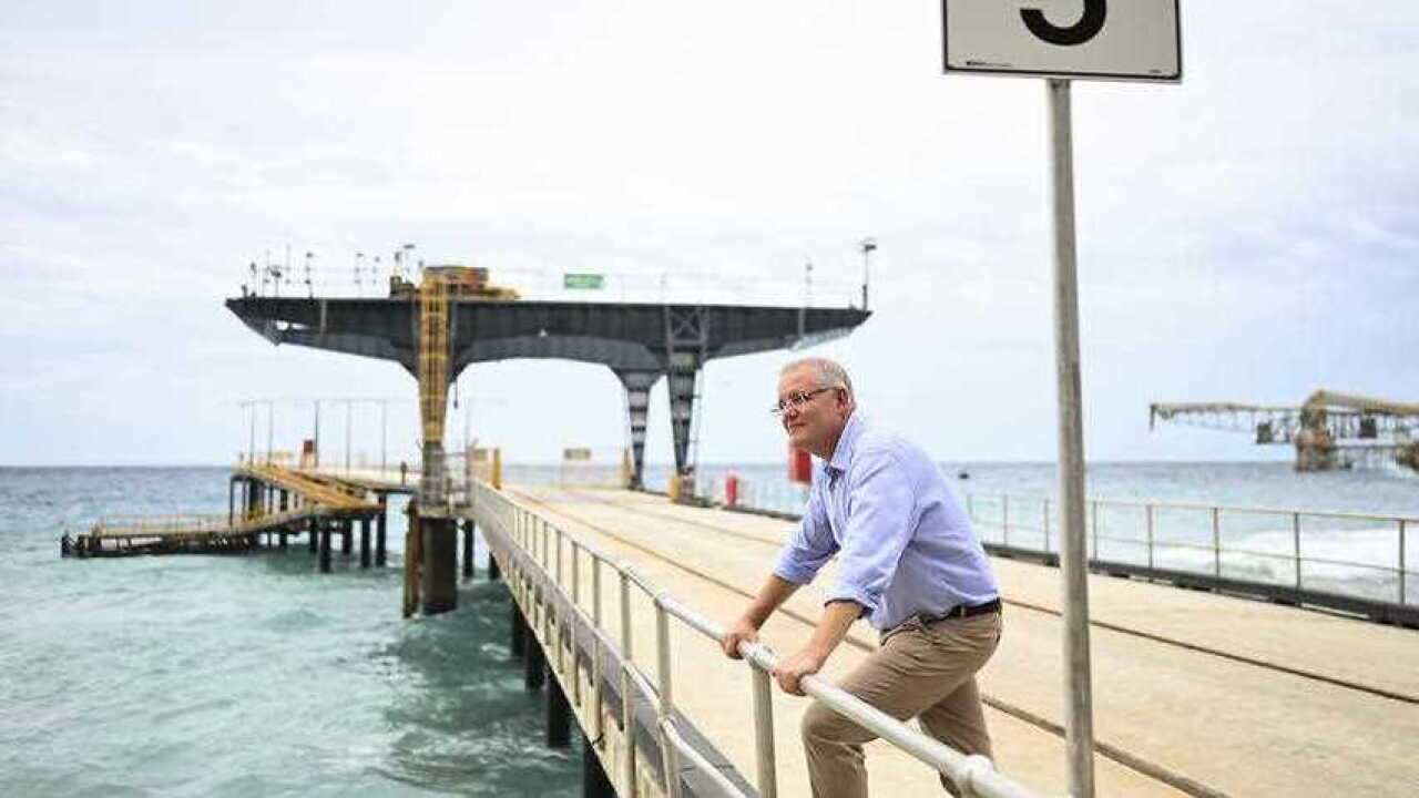Australian Prime Minister Scott Morrison poses for photographs on the jetty at Christmas Island