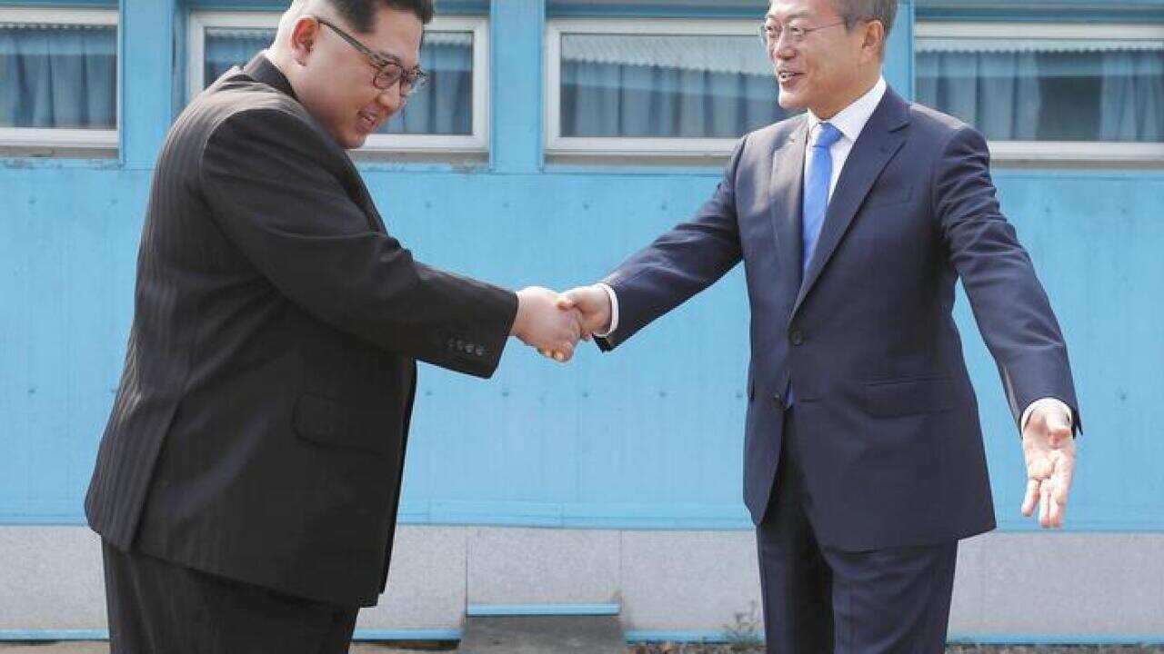 Kim Jong-un and Moon Jae-in shake hands in the DMZ