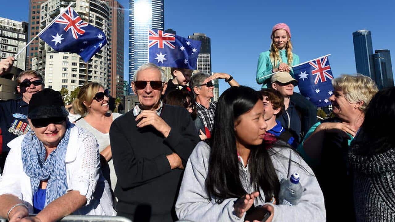 Crowds waving Australian flags